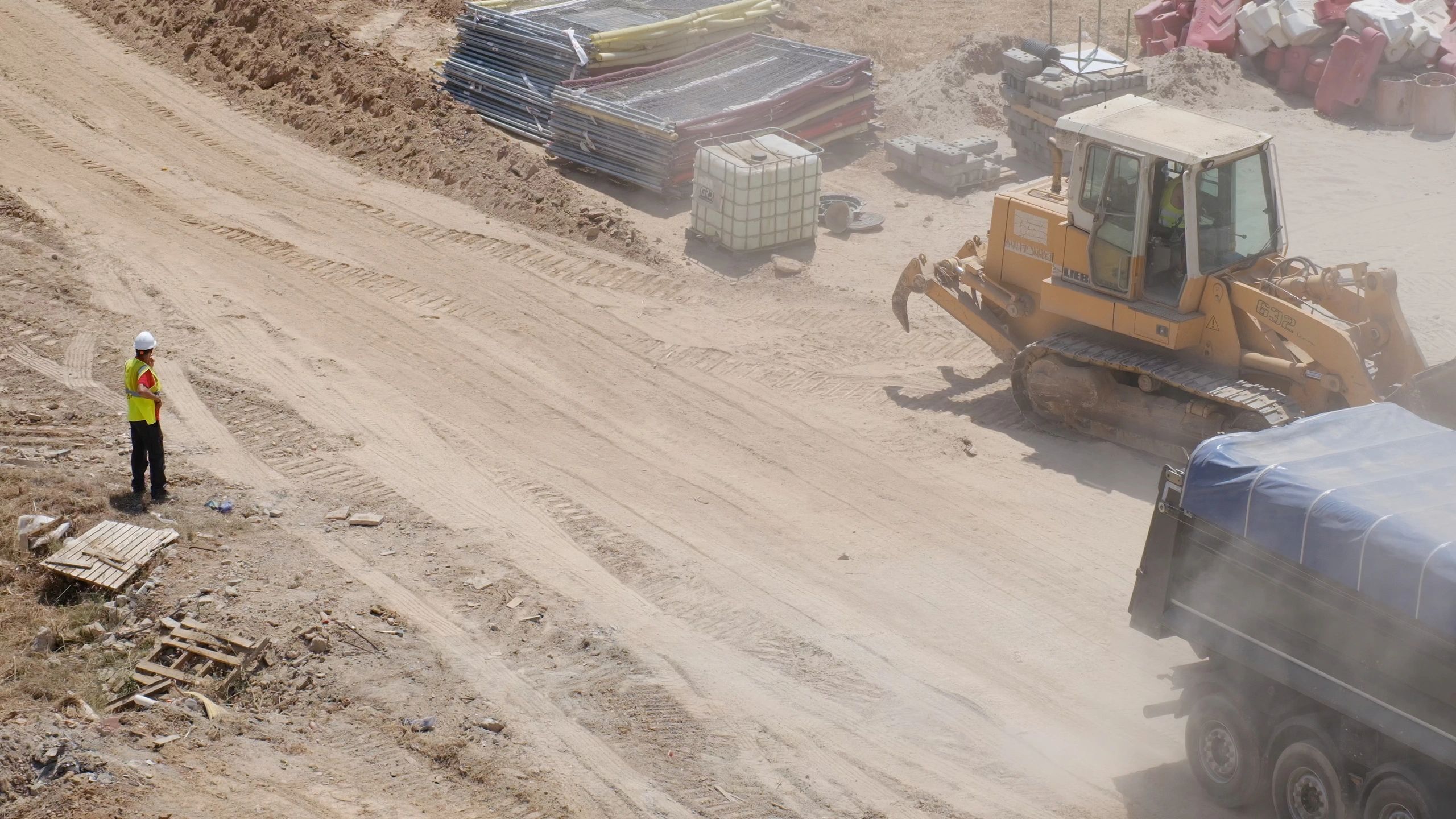 Team member supervising material loading and site operations